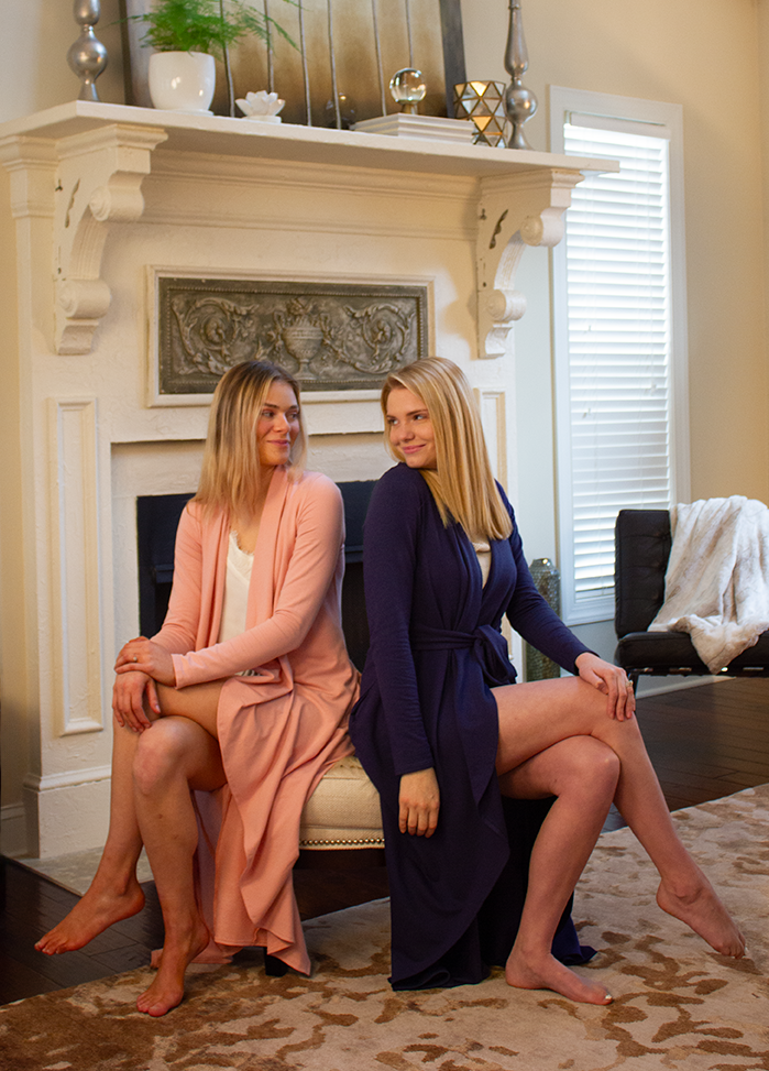 Two women wearing long knit robes